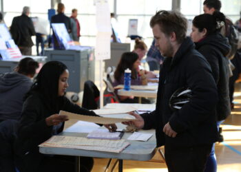 Un votante recibe su boleta en un centro de votación durante una elección en Estados Unidos