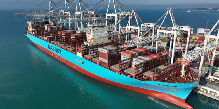 Buque de carga con contenedores en un puerto, símbolo del comercio internacional