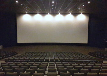 Interior de una sala de cine con butacas y pantalla